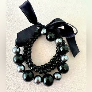 Fashion bracelet pearl finish stretchable, bow ribbon.